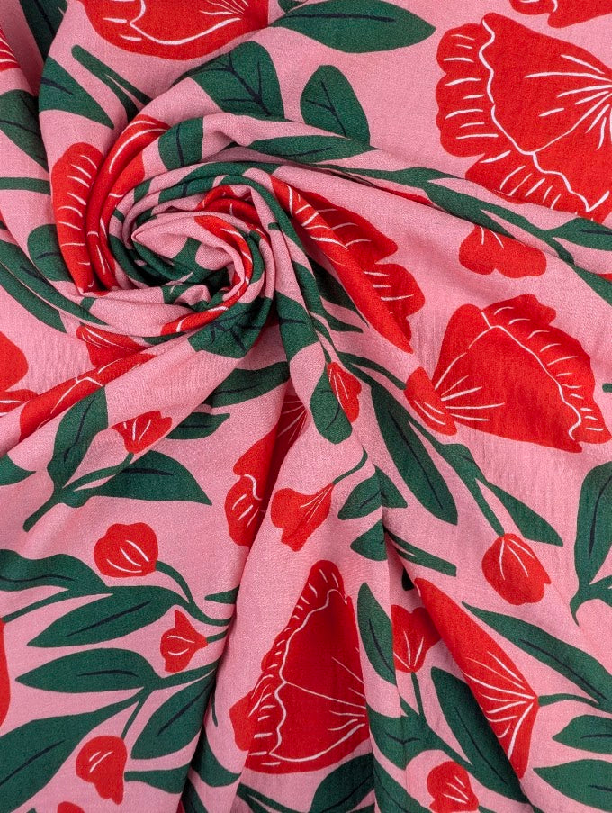 Heavy linen-look viscose with red floral print and green foliage 1